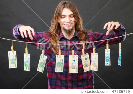 Rich man with laundry of money 47386739