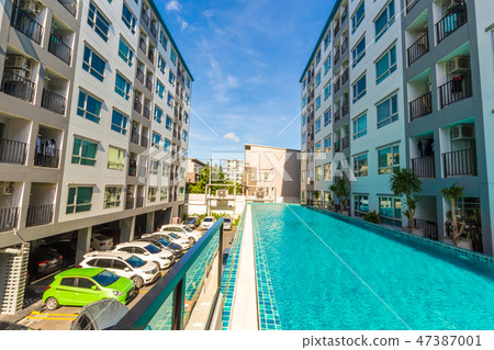 condominium building with swimming pool blue sky 47387001