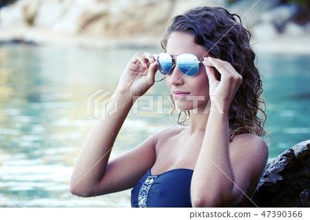 Beautiful girl in bikini swimming in sea Beautiful girl in bikini swimming in sea 47390366
