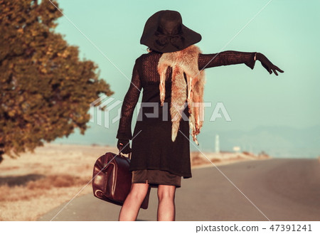 Retro beautiful blond woman portrait on road Retro beautiful blond woman portrait on road 47391241