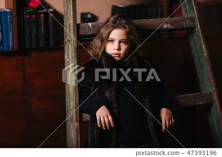 Little girl stand by the ladder in the library. Books Little girl stand by the ladder in the library. Books 47393196