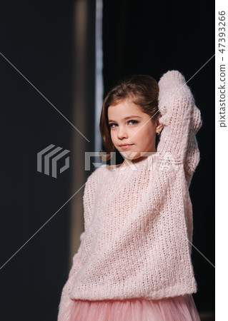 Beautiful young model in a peach color knitted sweater. Fashion makeup and hairstyle 47393266