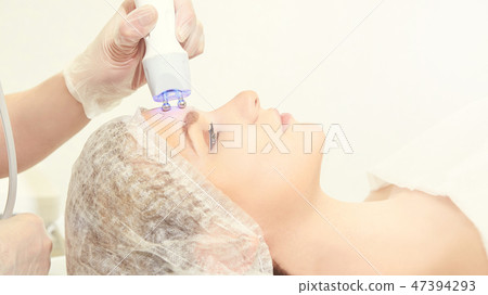 Facial micro current cosmetology procedure 47394293