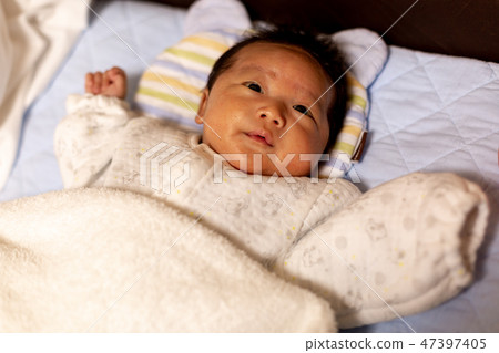 A baby sleeping in bed A baby sleeping in bed 47397405