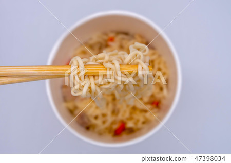 Hot instant noodle in the wooden chopsticks 47398034