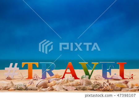 travel written in colorful letters on the beach 47398107