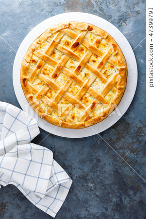 Pie with salted soft cheese and greens, top view Pie with salted soft cheese and greens, top view 47399791