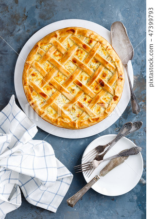 Pie with salted soft cheese and greens, top view 47399793