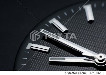 Close up clockwise on black clock face background. 47400646