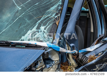 Total loss car with broken windscreen, axle fracture and police barrier band Total loss car with broken windscreen, axle fracture and police barrier band 47401509