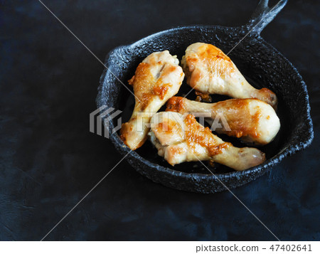 Fried chicken legs on an old pan on a black table. 47402641