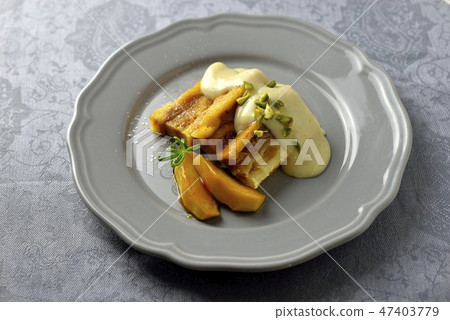 Bread pudding with custard sauce / bread and butter pudding 47403779