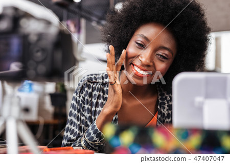 Pretty dark-skinned woman with bright makeup looking good 47407047