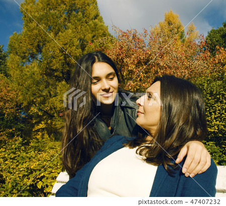 mature real mother with daughter outside autumn fall in park smiling 47407232
