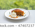 A piece of apple cake on white dish 47407237