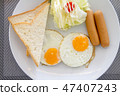 American breakfast dish with eggs, sausage, bread  47407243