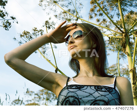 Young cute smiling woman in green park , lifestyle concept happy people Young cute smiling woman in green park , lifestyle concept happy people 47407276