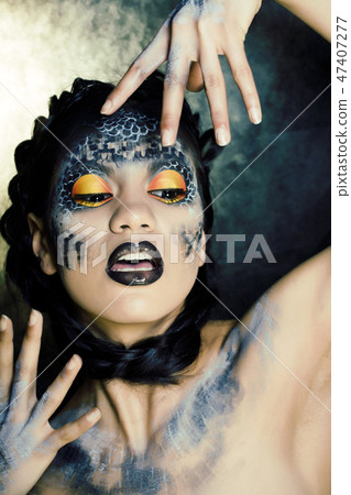 fashion portrait of pretty young woman with creative make up like a snake, halloween close up 47407277