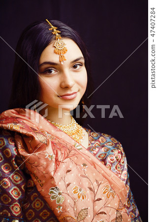 beauty sweet real indian girl in sari smiling on black background, jewelry shining beauty sweet real indian girl in sari smiling on black background, jewelry shining 47407284