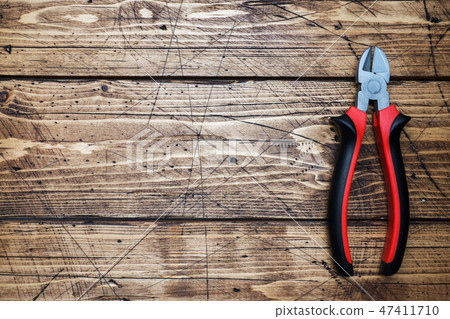 Pliers tongs on wooden background with copy space. Pliers tongs on wooden background with copy space. 47411710