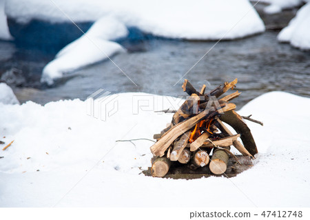 Campfire on snow in the winter forest 47412748