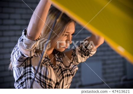Car repair service. Young sexy woman stands in front of an opened car hood Car repair service. Young sexy woman stands in front of an opened car hood 47413621