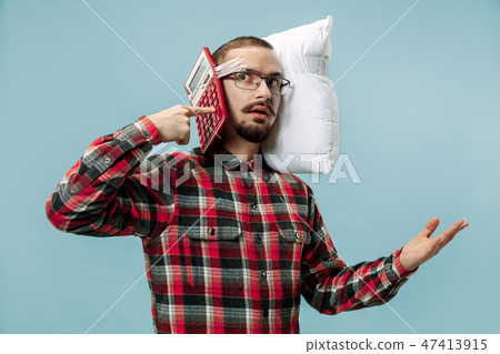 Tired man sleeping at home having too much work. Bored businessman with pillow 47413915