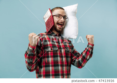 Tired man sleeping at home having too much work. Bored businessman with pillow 47413916