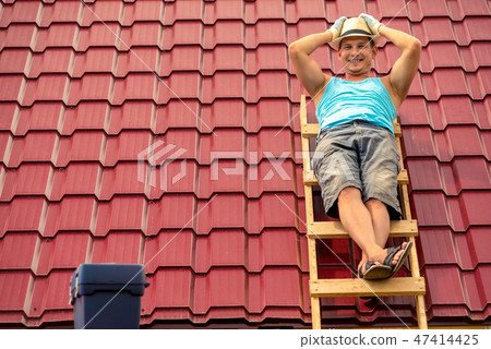 Happy man posing on the stairs 47414425