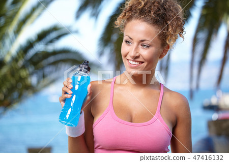 fitness and dieting concept - smiling sporty woman with bottle o fitness and dieting concept - smiling sporty woman with bottle o 47416132