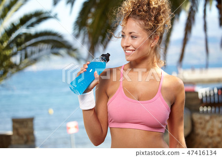 fitness and dieting concept - smiling sporty woman with bottle o fitness and dieting concept - smiling sporty woman with bottle o 47416134