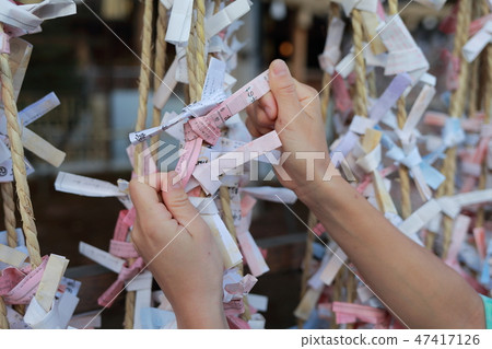 Hands tying a fortune 47417126