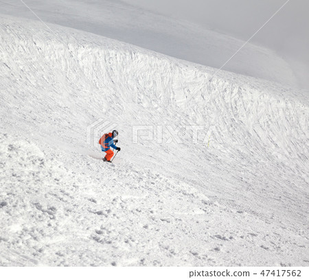 Skier downhill on freeriding slope and misty sky Skier downhill on freeriding slope and misty sky 47417562
