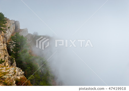 Clouds high in mountains, mountain peaks coming Clouds high in mountains, mountain peaks coming 47419918