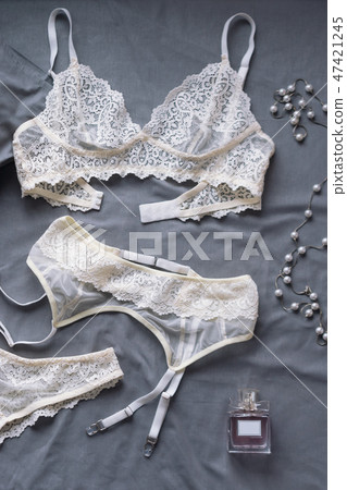 Set of glamorous stylish sexy lace lingerie with woman accessories on grey bedsheets background Set of glamorous stylish sexy lace lingerie with woman accessories on grey bedsheets background 47421245