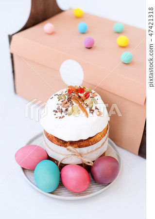 Easter cake, colored eggs. Orthodox sweet bread, kulich and other traditional food on light 47421318