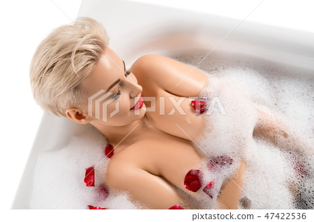 Beautiful blonde in bath with foam and rose petals 47422536