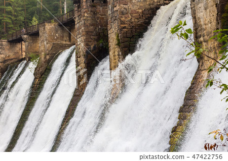 Water flowing down the walls of the old small hydropower plants Water flowing down the walls of the old small hydropower plants 47422756
