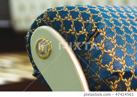 Close-up element of the textile decoration of a soft bedside chair in the bedroom. Luxury furniture 47424561