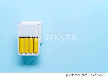 Image of charger with yellow batteries Image of charger with yellow batteries 47425728