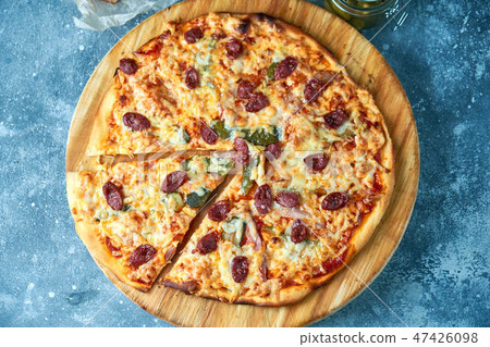 Slice of hot pizza large cheese lunch or dinner crust seafood meat topping sauce. with bell pepper 47426098