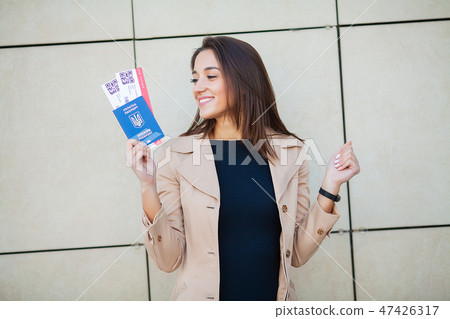 Business woman holding air tickets. Traveller walking the airport hall 47426317