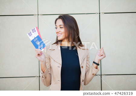 Business woman holding air tickets. Traveller walking the airport hall 47426319