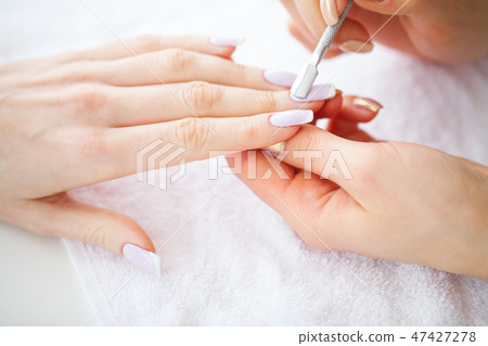 SPA manicure. French manicure at spa salon. Woman hands in a nail salon receiving a manicure SPA manicure. French manicure at spa salon. Woman hands in a nail salon receiving a manicure 47427278
