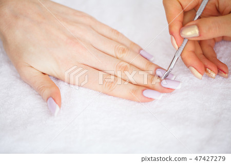 SPA manicure. French manicure at spa salon. Woman hands in a nail salon receiving a manicure SPA manicure. French manicure at spa salon. Woman hands in a nail salon receiving a manicure 47427279