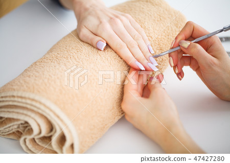 SPA manicure. French manicure at spa salon. Woman hands in a nail salon receiving a manicure SPA manicure. French manicure at spa salon. Woman hands in a nail salon receiving a manicure 47427280