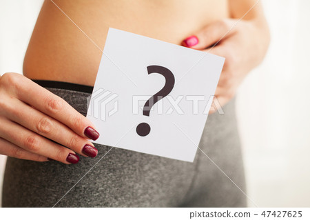 Health. Woman Body In Underwear With Question Card Near Belly 47427625