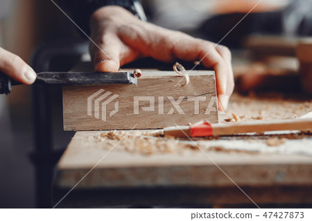 The carpenter works with a tree The carpenter works with a tree 47427873