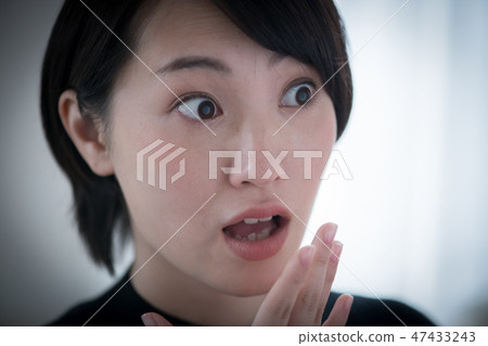 A young Japanese woman who is shocked 47433243