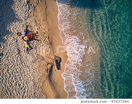 Beautiful beach with family top view shot Beautiful beach with family top view shot 47437264